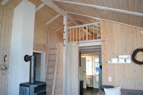 a living room with a woodburning stove in a room at Ferienhaus "Deichglück" direkt an der Nordsee in Wesselburenerkoog