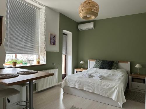 a bedroom with a bed and a desk and a table at Holiday on top City Center in Budapest
