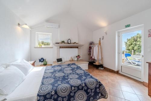 a bedroom with a bed and a desk and a window at Holiday home Horizont in Supetar