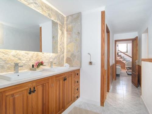 a bathroom with two sinks and a mirror at Ca sa Padrina in Colonia Sant Jordi