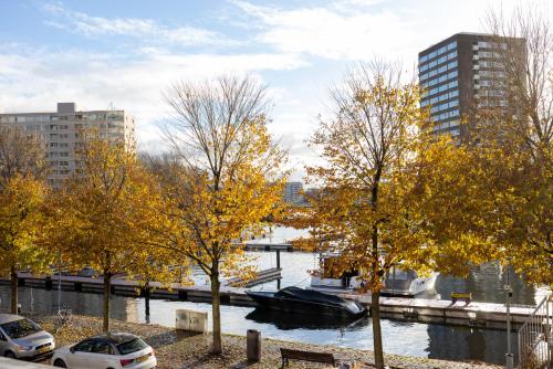 a boat in the water in a city with buildings at d'Ouwe Moer Apartment in Rotterdam