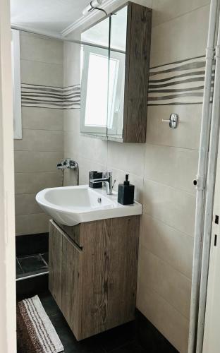 a bathroom with a sink and a mirror at Bella Vista Apartment in Chios