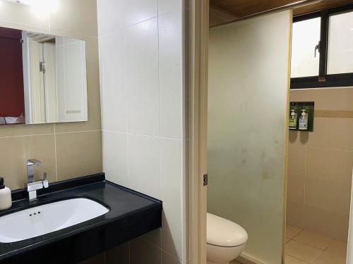 a bathroom with a sink and a toilet at Chuxu Homestay in Fanlu
