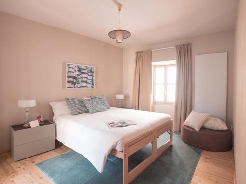 a bedroom with a large white bed and a window at B&B CCAA Ascona in Ascona