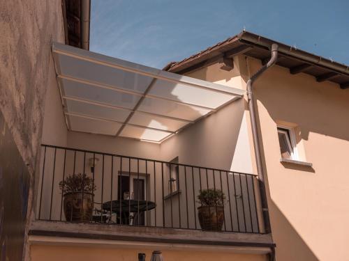 a balcony with a solarium on a building at B&B CCAA Ascona in Ascona