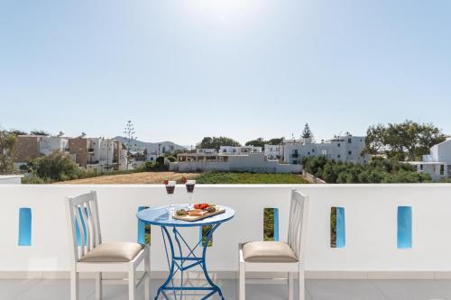 a table and chairs on a balcony with a view at Arhontiko in Naxos Chora