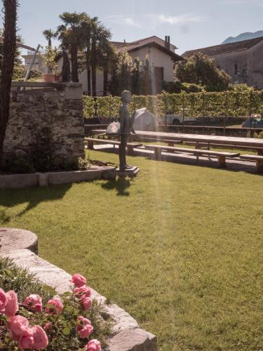 a statue of a person on a skateboard in a park at B&B CCAA Ascona in Ascona