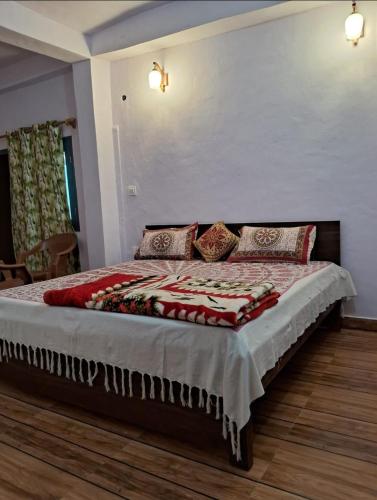 a bedroom with a large bed in a room at Pathgami homestay kainchi dhaam in Bhowāli