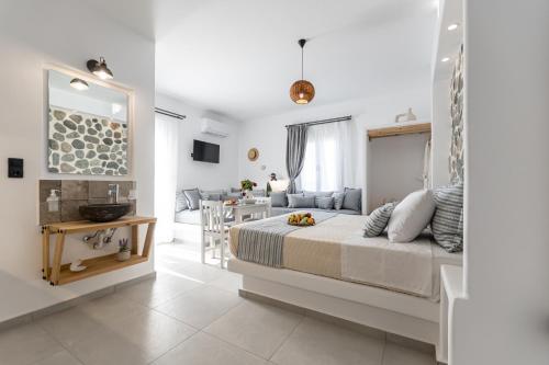 a bedroom with a bed and a living room at Arhontiko in Naxos Chora