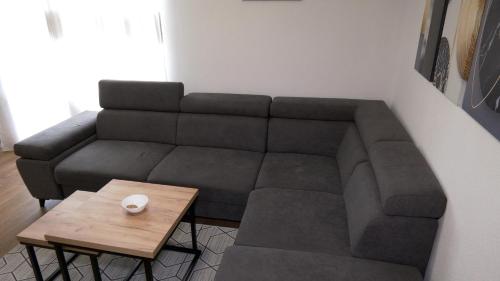 a living room with a couch and a coffee table at Kuća za odmor GAVRIĆ in Mrkonjić Grad