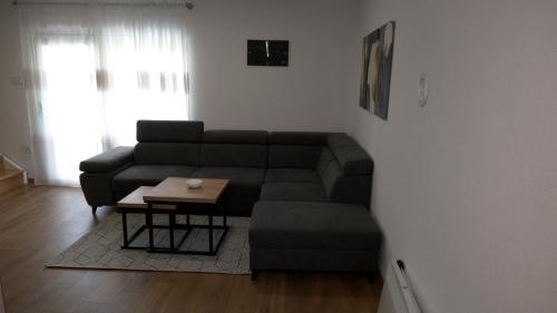 a living room with a couch and a coffee table at Kuća za odmor GAVRIĆ in Mrkonjić Grad