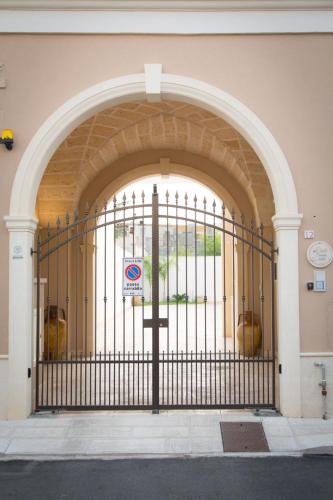 an entrance to a building with a black gate at InCanti Salentini Apartments in Surbo