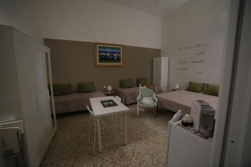 a living room with a couch and a bed and a table at "Le Dimore degli Artisti" RIPACANDIDA in Ripacandida