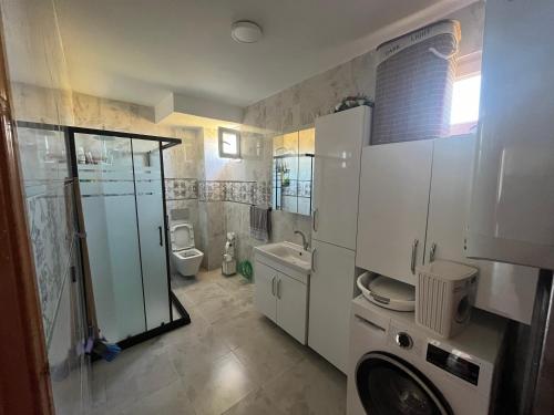 a bathroom with a shower and a toilet and a sink at Airport See Viem Apartment in Arnavutköy