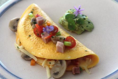 a white plate with a taco with vegetables on it at Beach Break B&B - Solar Powered in Port Alfred