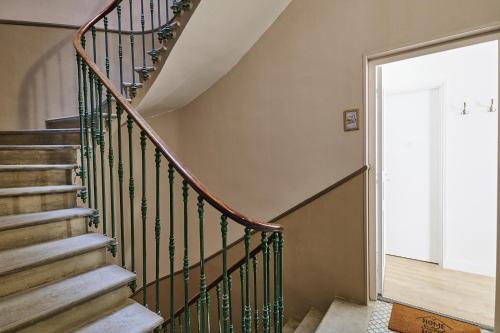 a staircase with green railings in a house at Le Flourens by Paul Riquet 1609 Residences in Béziers
