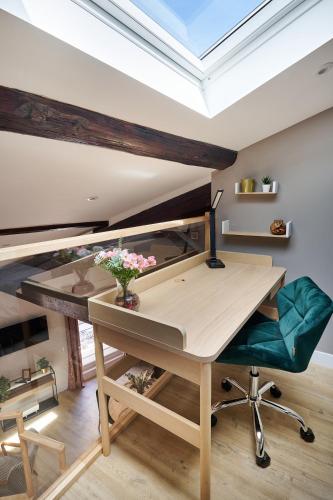an office with a desk and a green chair at Le Flourens by Paul Riquet 1609 Residences in Béziers