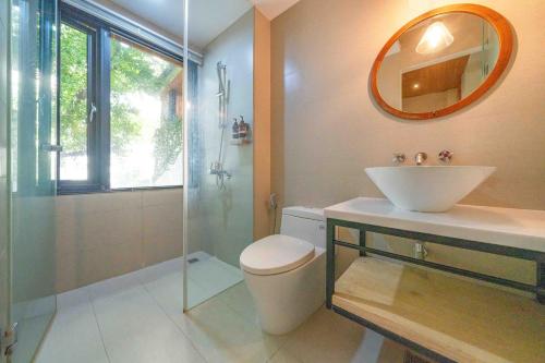 a bathroom with a toilet and a sink and a shower at Tree House in Tainan