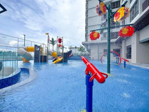 a swimming pool with a water park with a playground at Bali Residences Melaka in Melaka