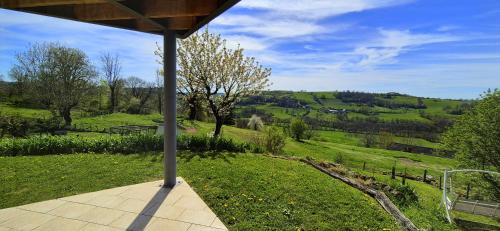 a porch with a view of a green field at La Grange - Gite Mur de Barrez in Mur-de-Barrez
