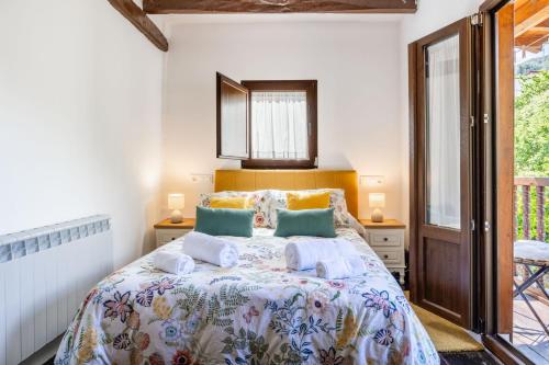 a bedroom with a bed and a window at Casa Raymonde in Potes