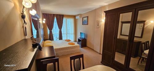 a room with a bedroom with a bed and a window at Частно студио в комплекс Поморие Ризорт in Pomorie