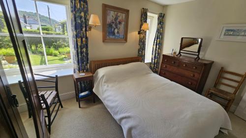 En eller flere senge i et værelse på Farm Cottage