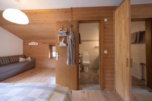 a room with a bed and a bathroom with a toilet at Leindlhof in Kössen