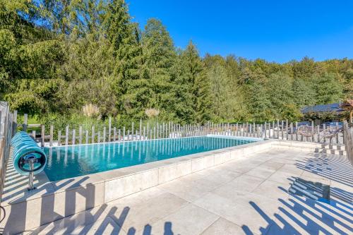 an empty swimming pool in a yard with trees at Bajsova domačija in Podčetrtek