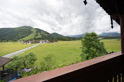 a view of a field with mountains in the background at Leindlhof in Kössen