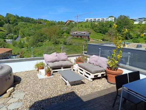 a patio with two couches and a table on a roof at Plena naturaleza en Pleno San Sebastián in Donostia-San Sebastián
