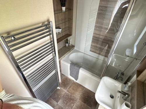 a bathroom with a shower and a toilet and a sink at Luxury Lake District Holiday Home-Sleeps 4 in Cockermouth