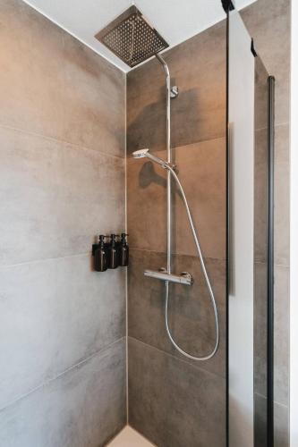 a shower with a shower head in a bathroom at NEU I Stilvoll I Boxspring I Smart TV I Zentral in Augsburg