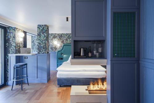 a hotel room with a bed and a fireplace at Latemar - Hotel Suites Spa in Soraga