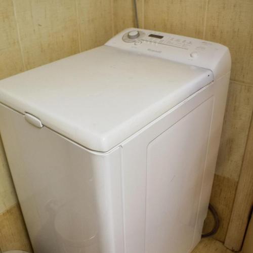 a close up of a white toilet in a bathroom at DA Sea Breeze next to the sea in Faraí