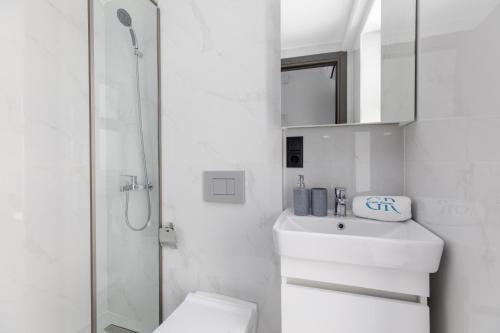 a bathroom with a toilet and a sink and a shower at Greek Rooms 1 in Kallithea Halkidikis