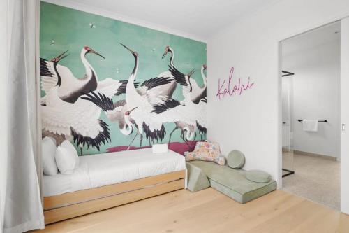 a bedroom with a mural of birds on the wall at Casa del Candelabra - Light-Filled Luxury Retreat Minutes from Town in Bellbrae