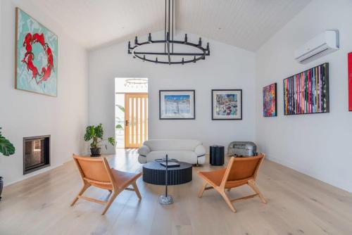 a living room with a couch and chairs and a chandelier at Casa del Candelabra - Light-Filled Luxury Retreat Minutes from Town in Bellbrae