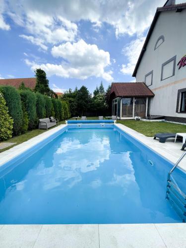 a swimming pool in the yard of a house at Riviera -ADULTS ONLY in Rewal