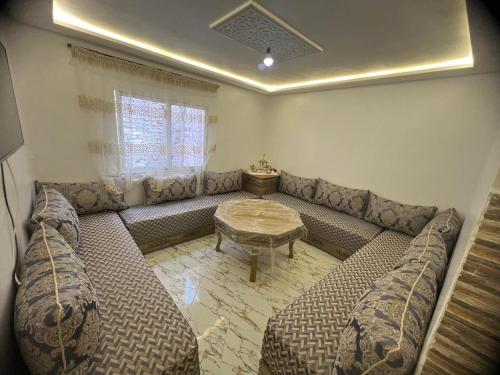 a living room with a couch and a table at مارتيل in Martil