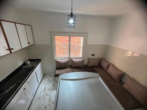 a small kitchen with a table and a window at مارتيل in Martil