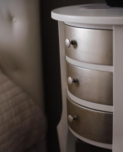 a wooden dresser with a white top next to a bed at Hotel Sole in Cannero Riviera