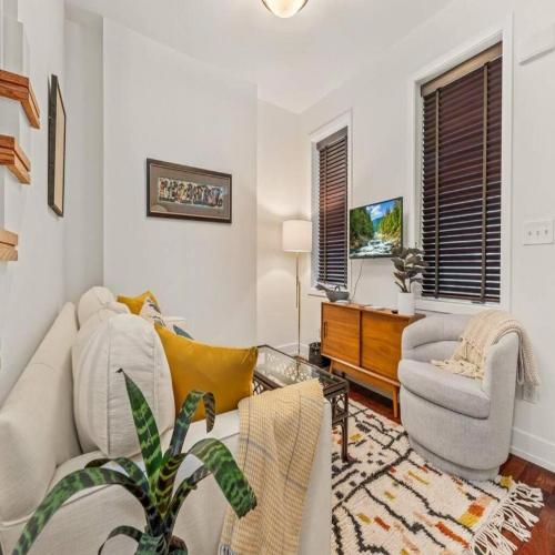 a living room with a couch and a chair at Bright & Modern Home with Patio in Philadelphia