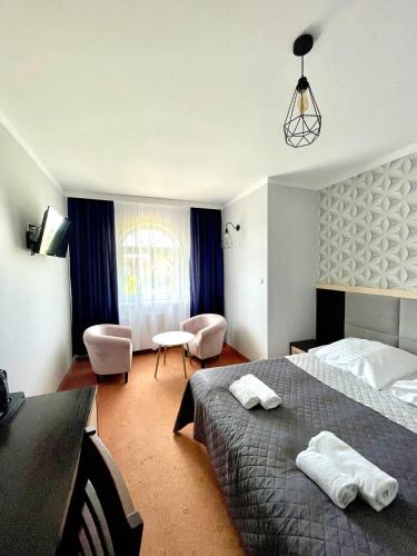 a hotel room with a bed and a desk and chair at Riviera -ADULTS ONLY in Rewal