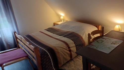 une petite chambre avec un lit et une table dans l'établissement petite chambre sympathique, à Hurtigheim