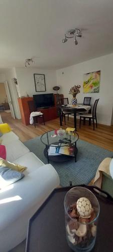 a living room with couches and tables and a living room at Apartamento do jardim in Cascais