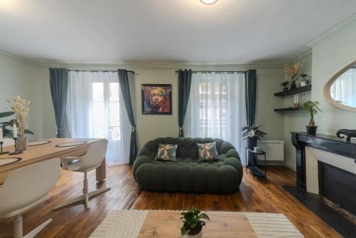a living room with a couch and a table at Eiffel Playcation in Paris