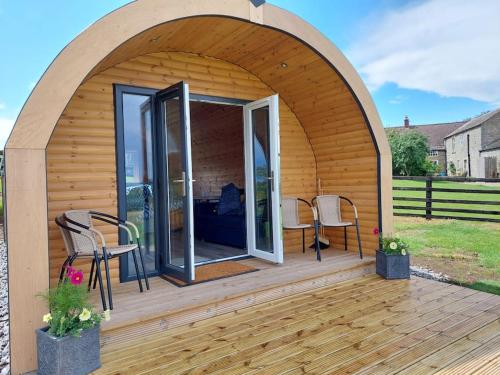 a gazebo with two chairs and a bed in it at High Whashton Springs Glamping Pod, Richmond Yorks in Richmond