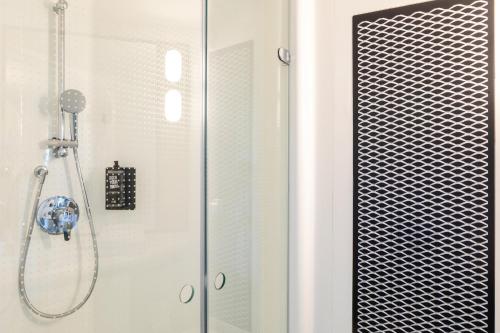 a shower with a glass door in a bathroom at ibis Paris CDG Airport in Roissy-en-France