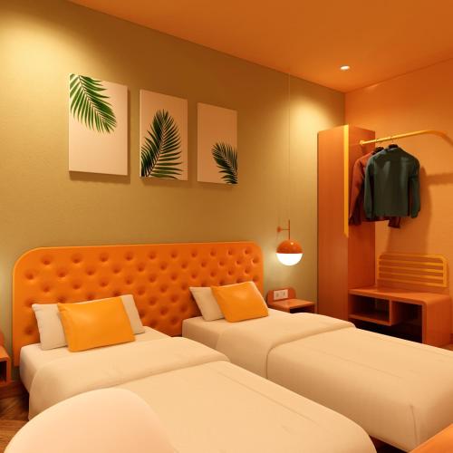 a hotel room with two beds and orange walls at Bloom Hotel - Golf Course Road, Sector 43 in Gurgaon